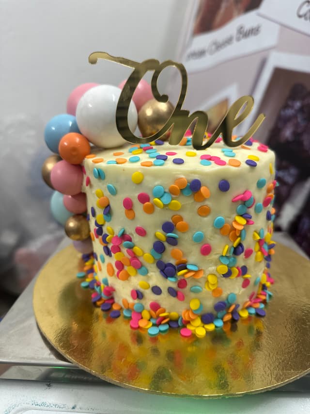 Childrens birthday cake decorated with Gems chocolate buttons